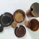 Pair of glazed stoneware cups with saucers and lids