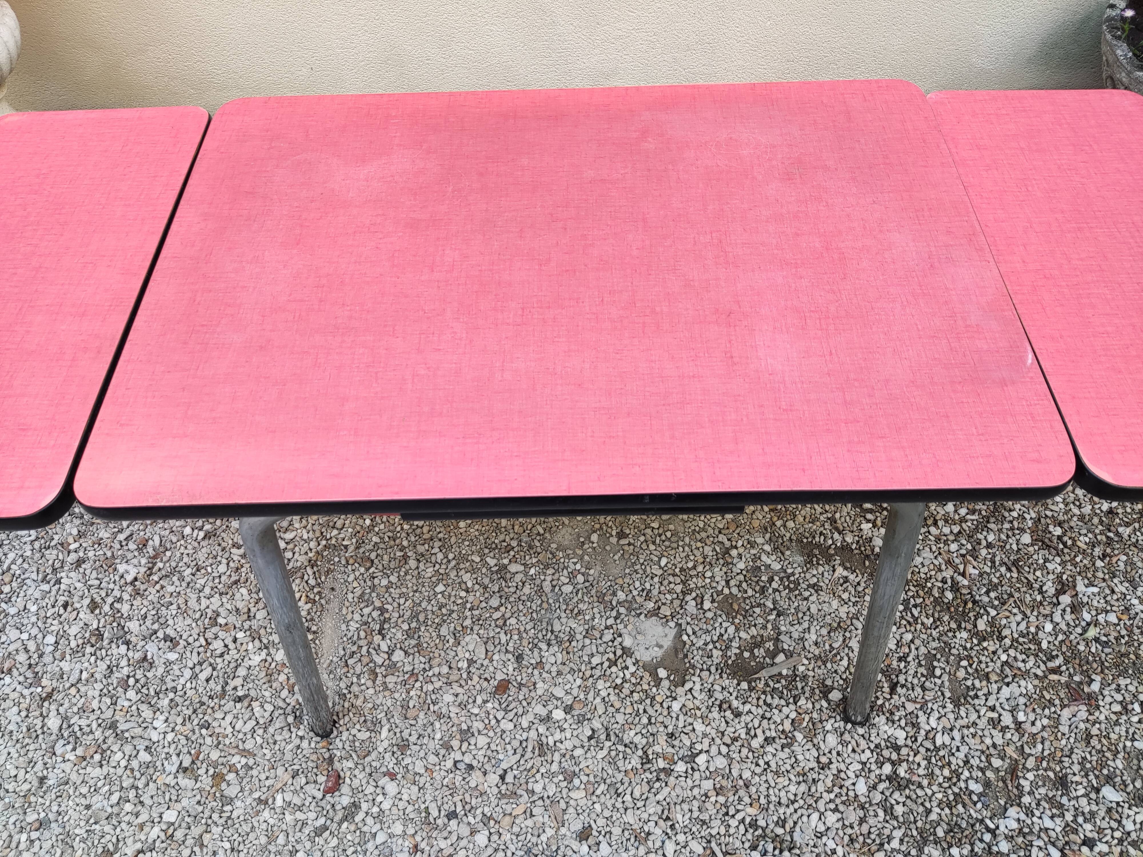 Table with two stools in red formica