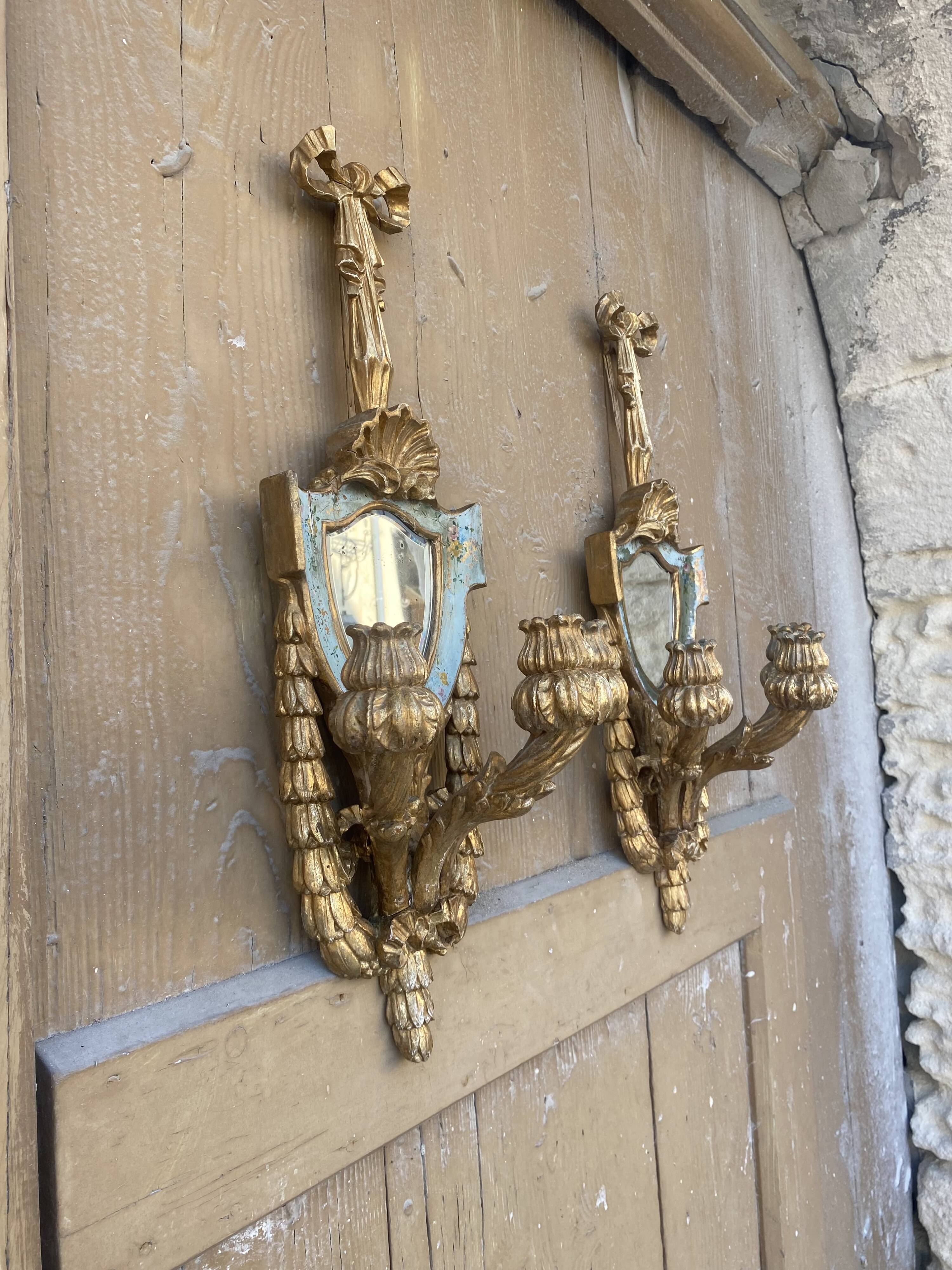 Pair of carved wood sconces