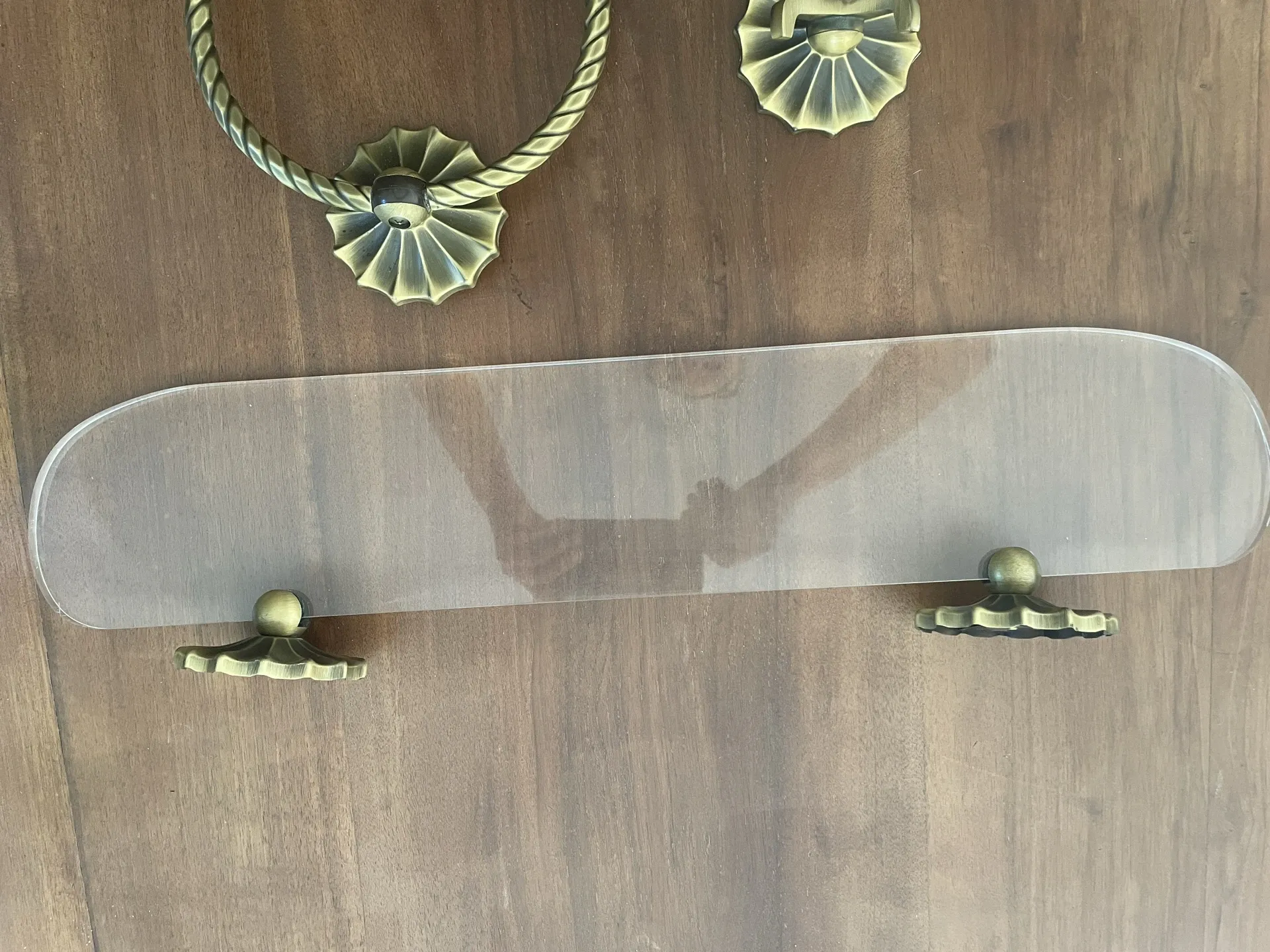 Vintage lucite and brass shelf with its hooks.