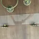 Vintage lucite and brass shelf with its hooks.