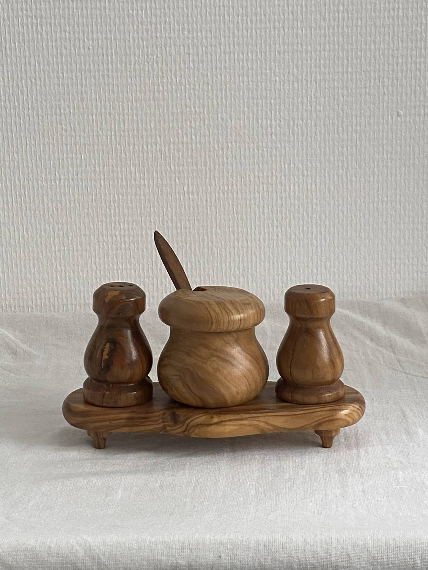 Condiment service (salt, pepper, and mustard) in olive wood