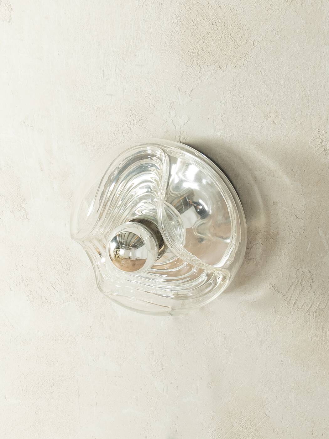 Sculptural wave wall lamp made of structured solid glass by peill & putzler