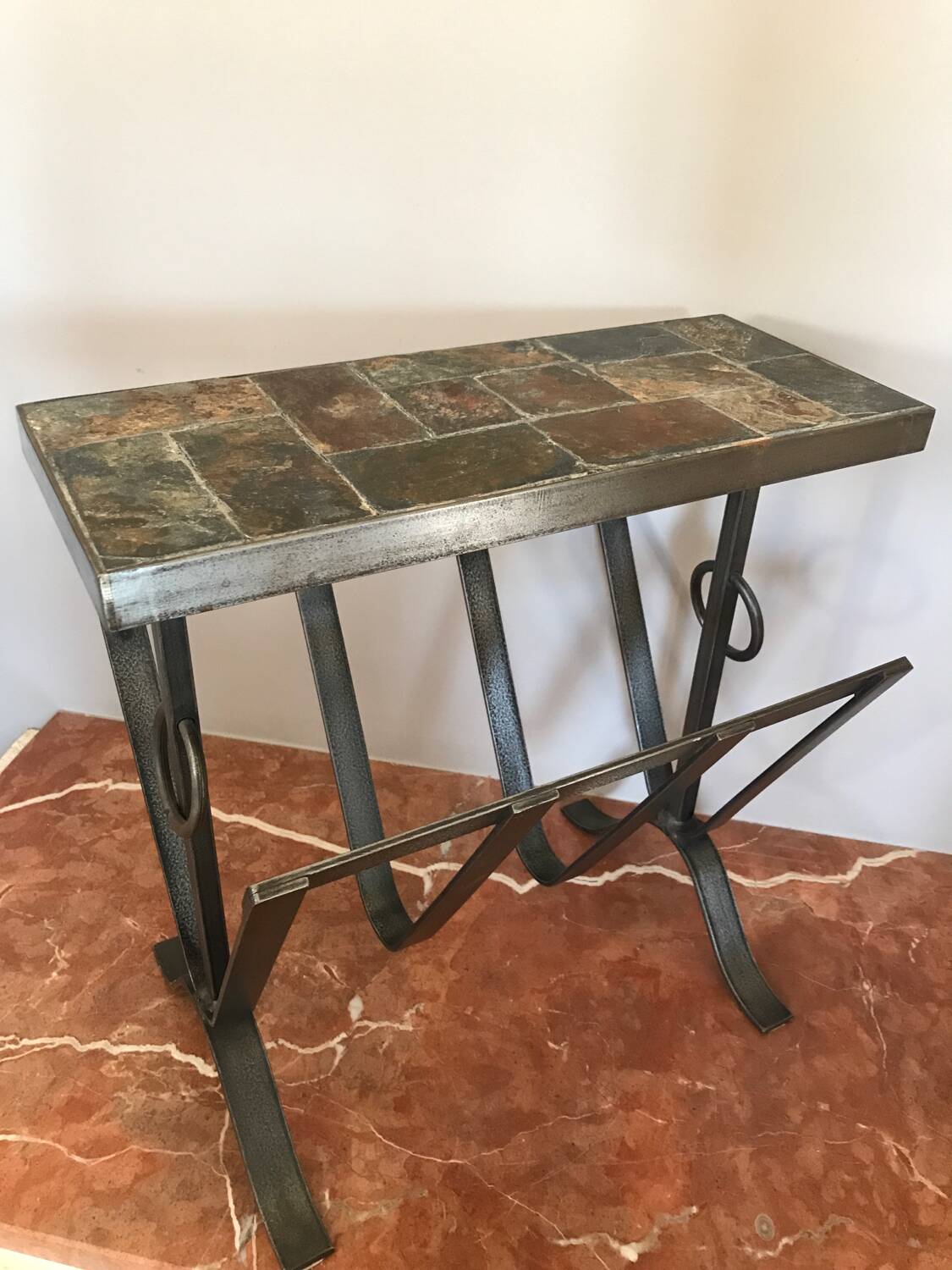 Iron and stone brutalist magazine rack