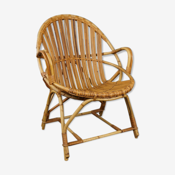 Rattan armchair with armrests