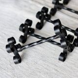 6 vintage black metal knife rests with scrollwork decoration