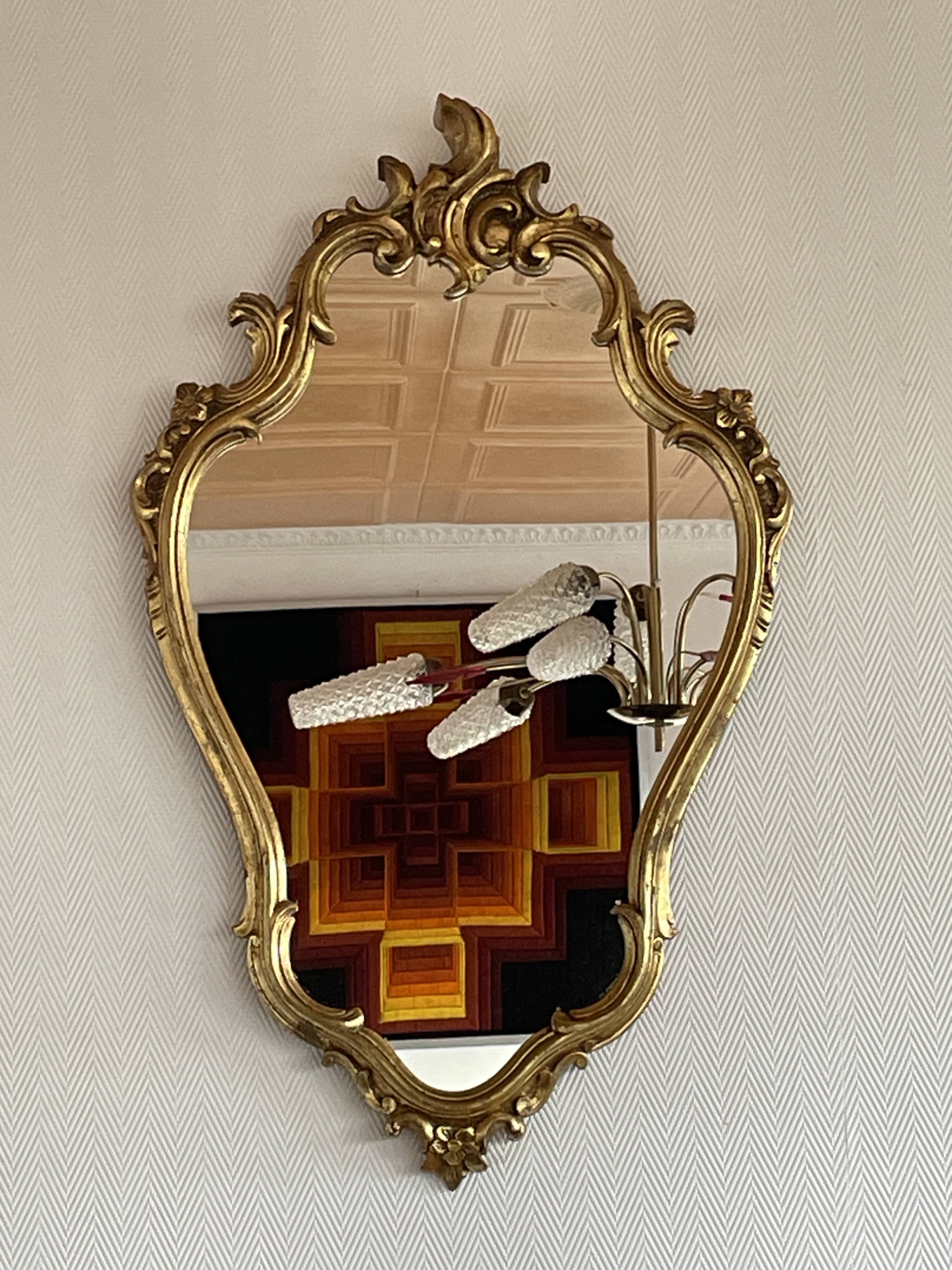 Old baroque style wall mirror with golden moldings