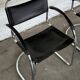 Vintage cantilever chairs in black saddle leather and chrome.