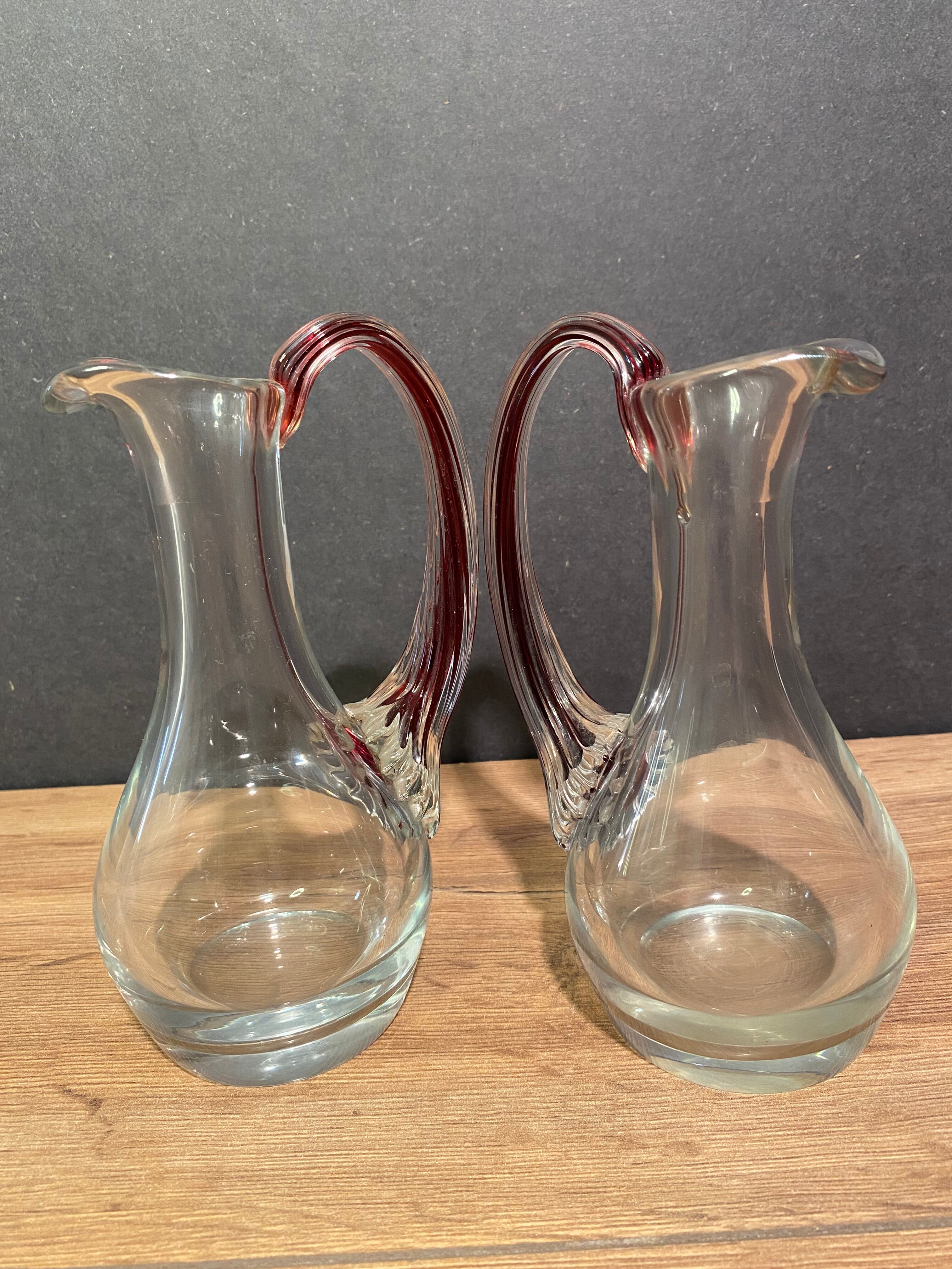 pair of crystal buires, handles with red tinted net decoration in the mass