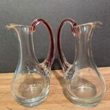 pair of crystal buires, handles with red tinted net decoration in the mass