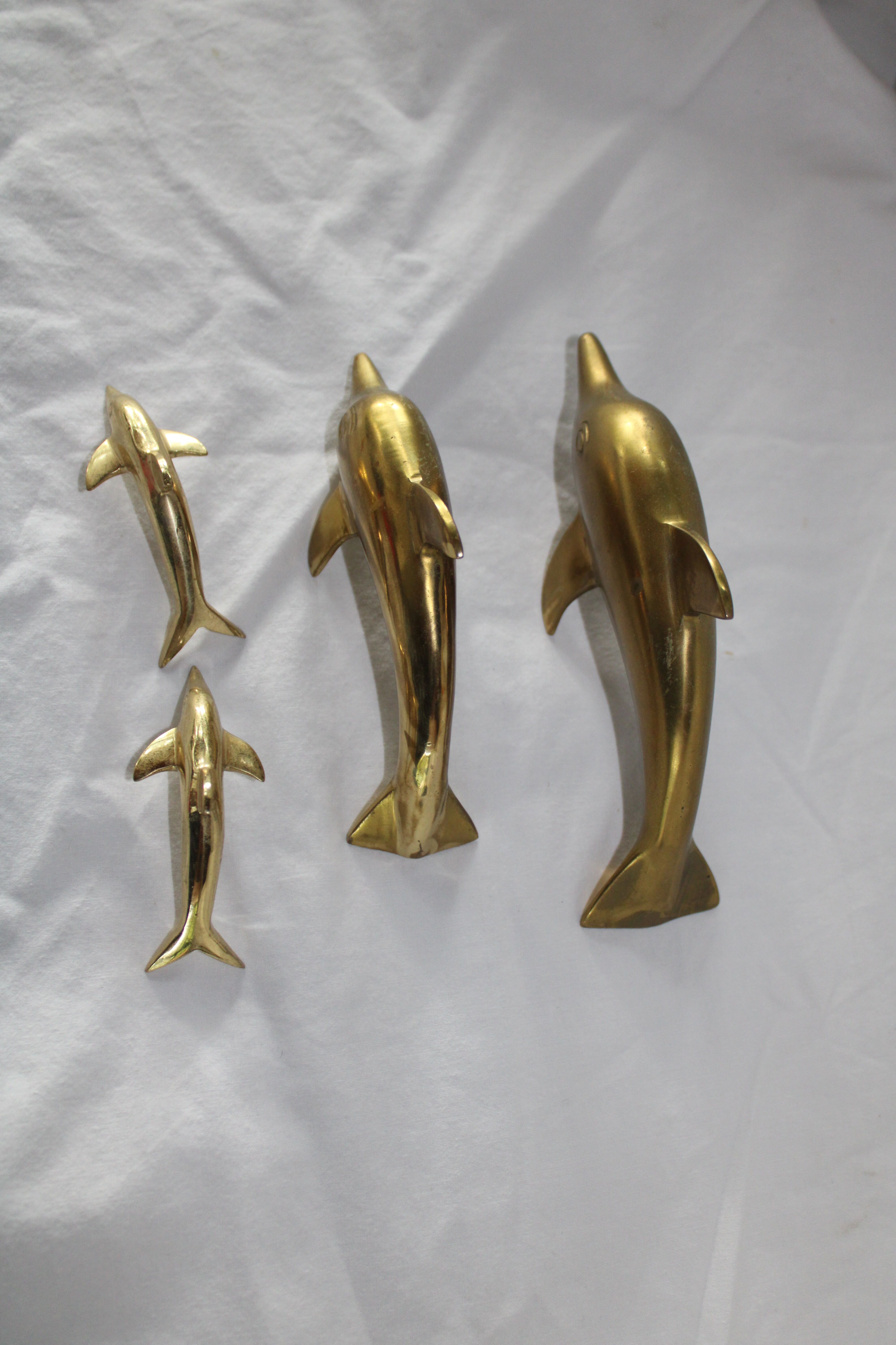Family of dolphins in vintage brass