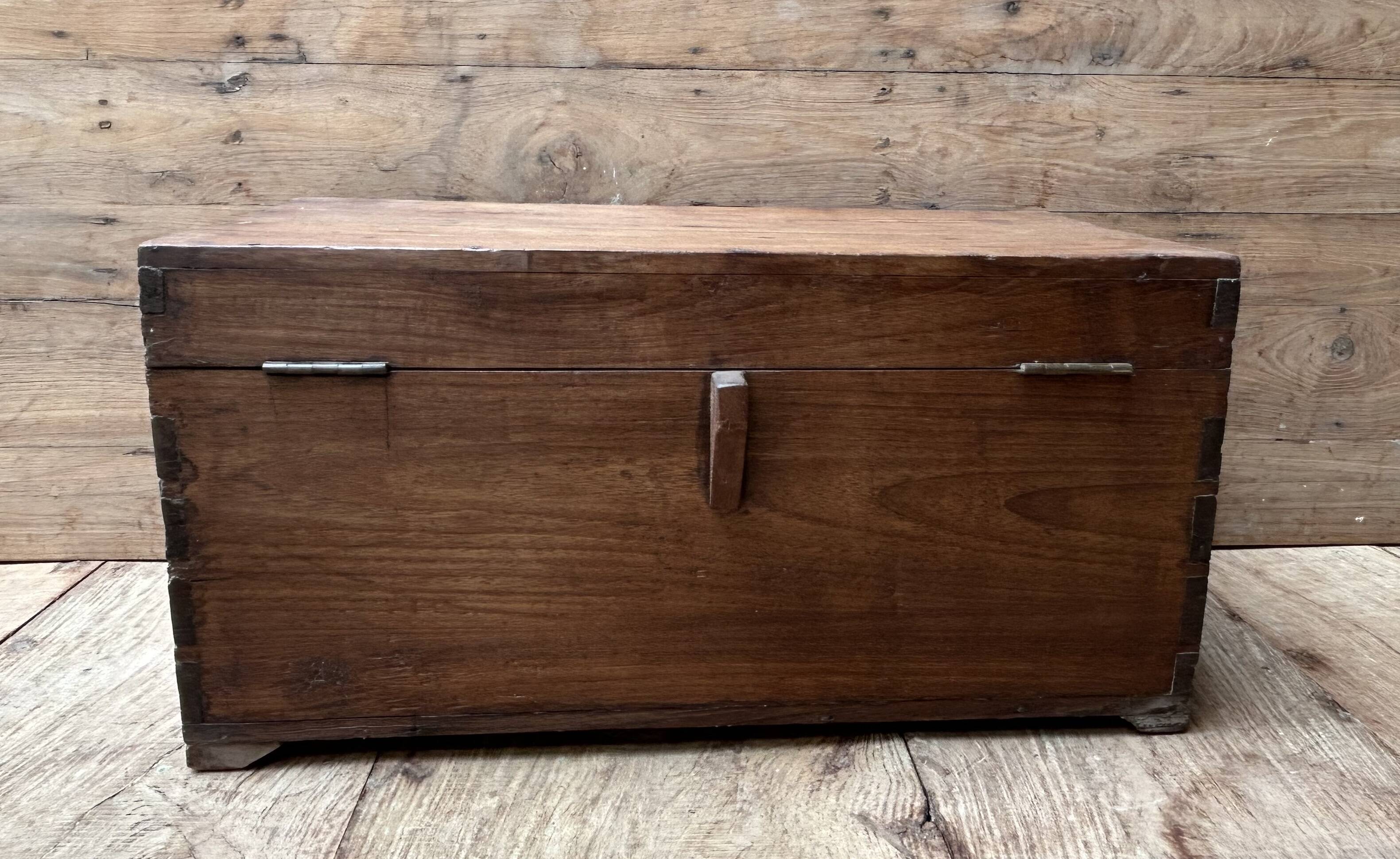 Teak chest from Burma with carved rosettes.