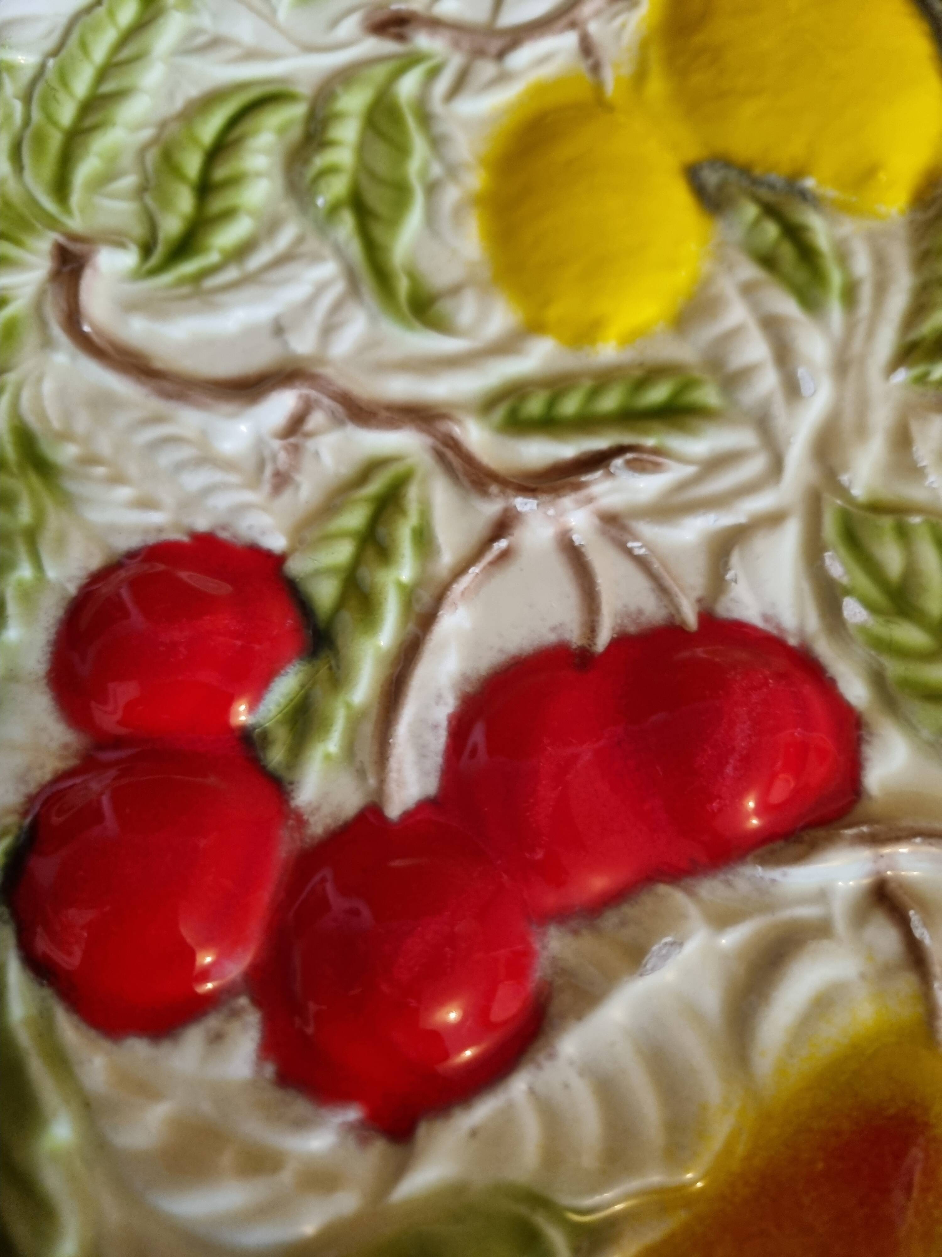 Large vintage earthenware dish with a fruit pattern.