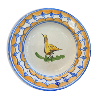 Earthenware plate representing a bird signed Lario