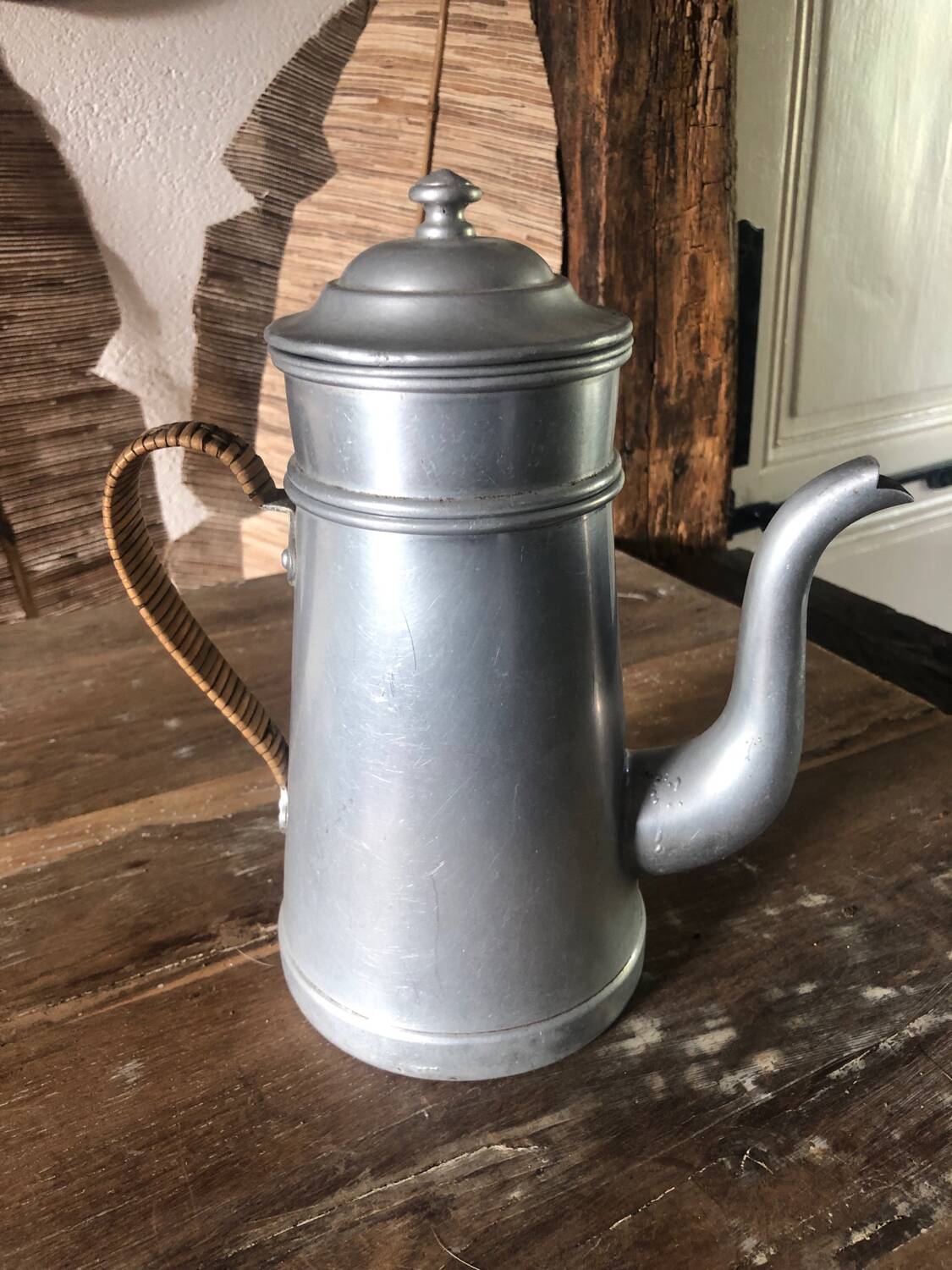 Old aluminum coffee maker, woven wicker handle
