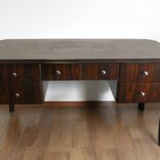 A large Art Deco style rosewood desk with 5 drawers and decorative motifs