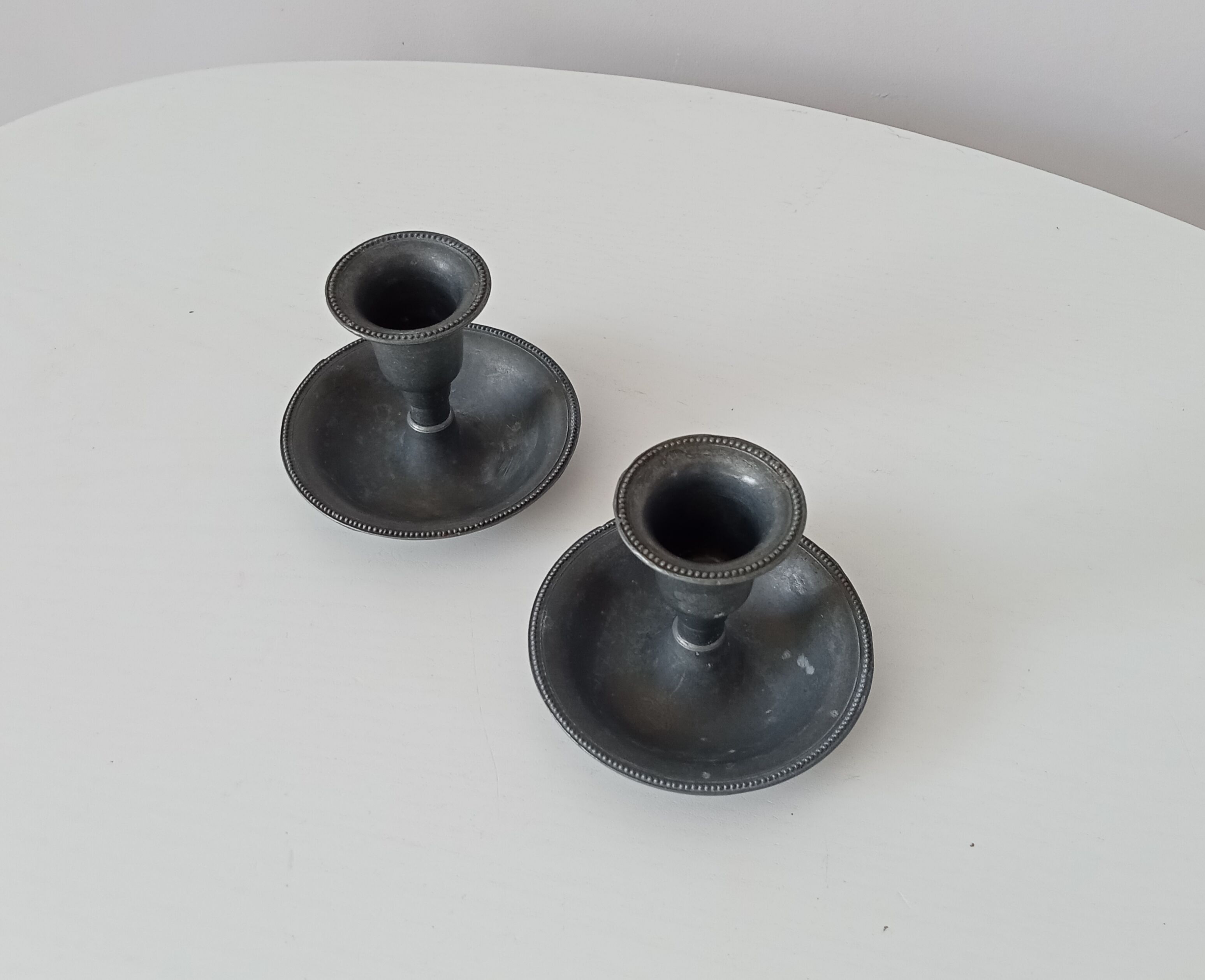 Pair of antique pewter candle holders