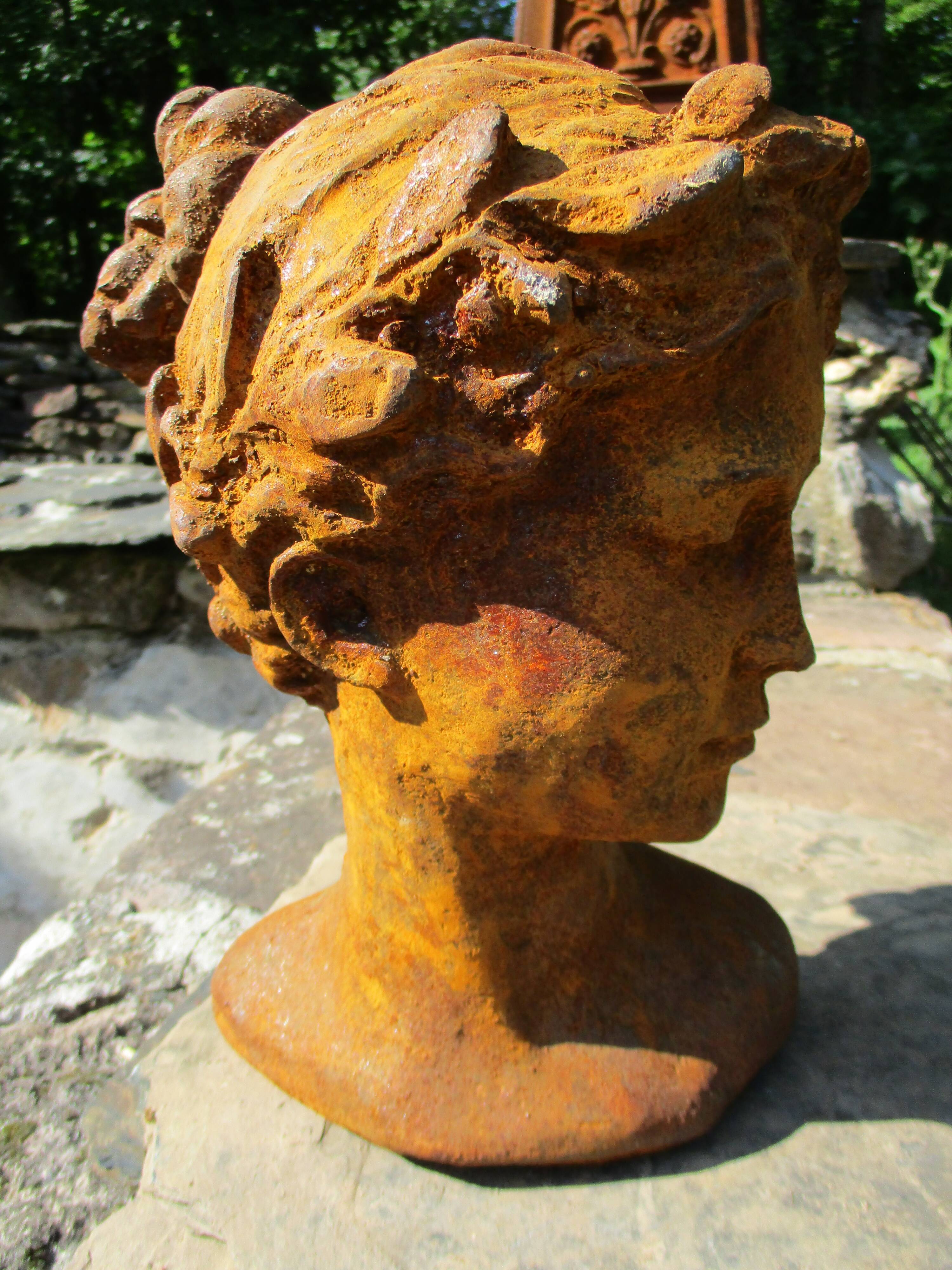 Cast iron sculpture of a woman.