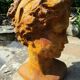 Cast iron sculpture of a woman.