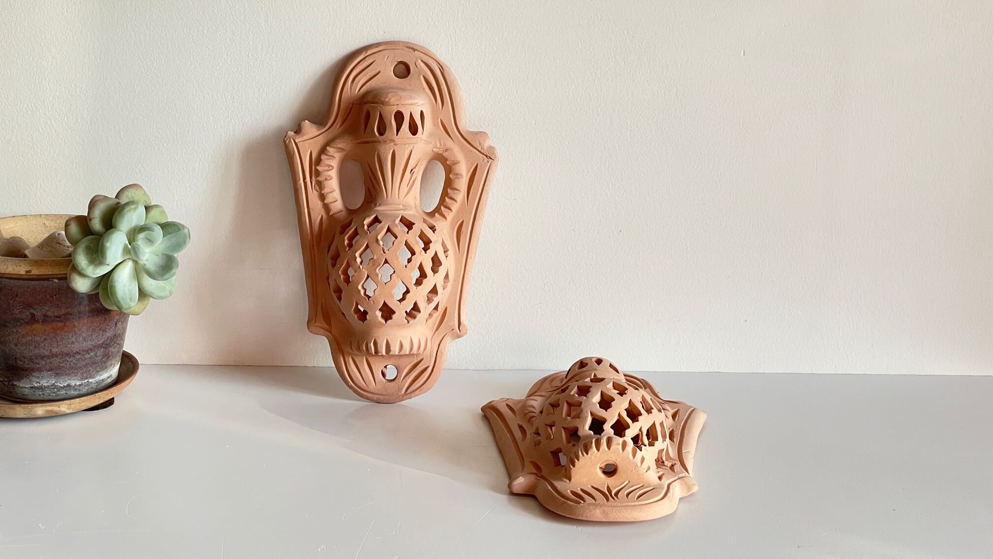 Pair of terracotta wall candle holders