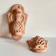 Pair of terracotta wall candle holders