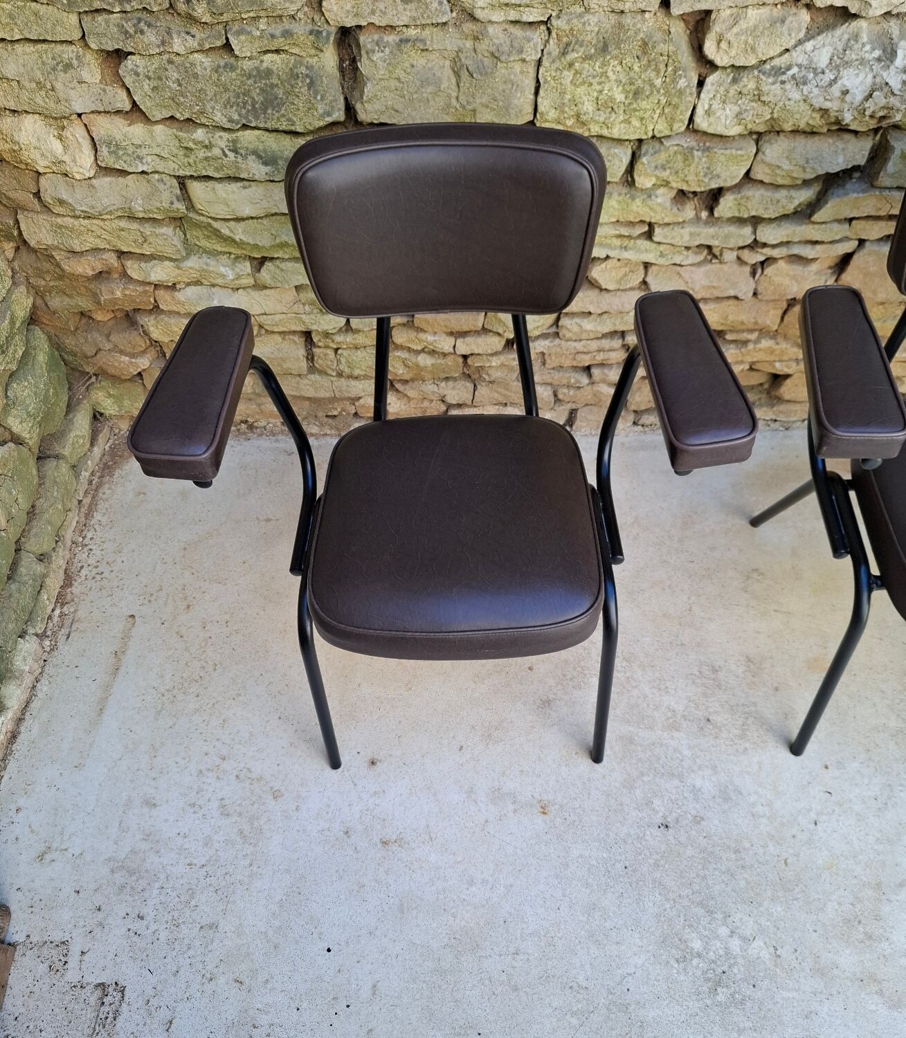 Brown faux leather armchairs