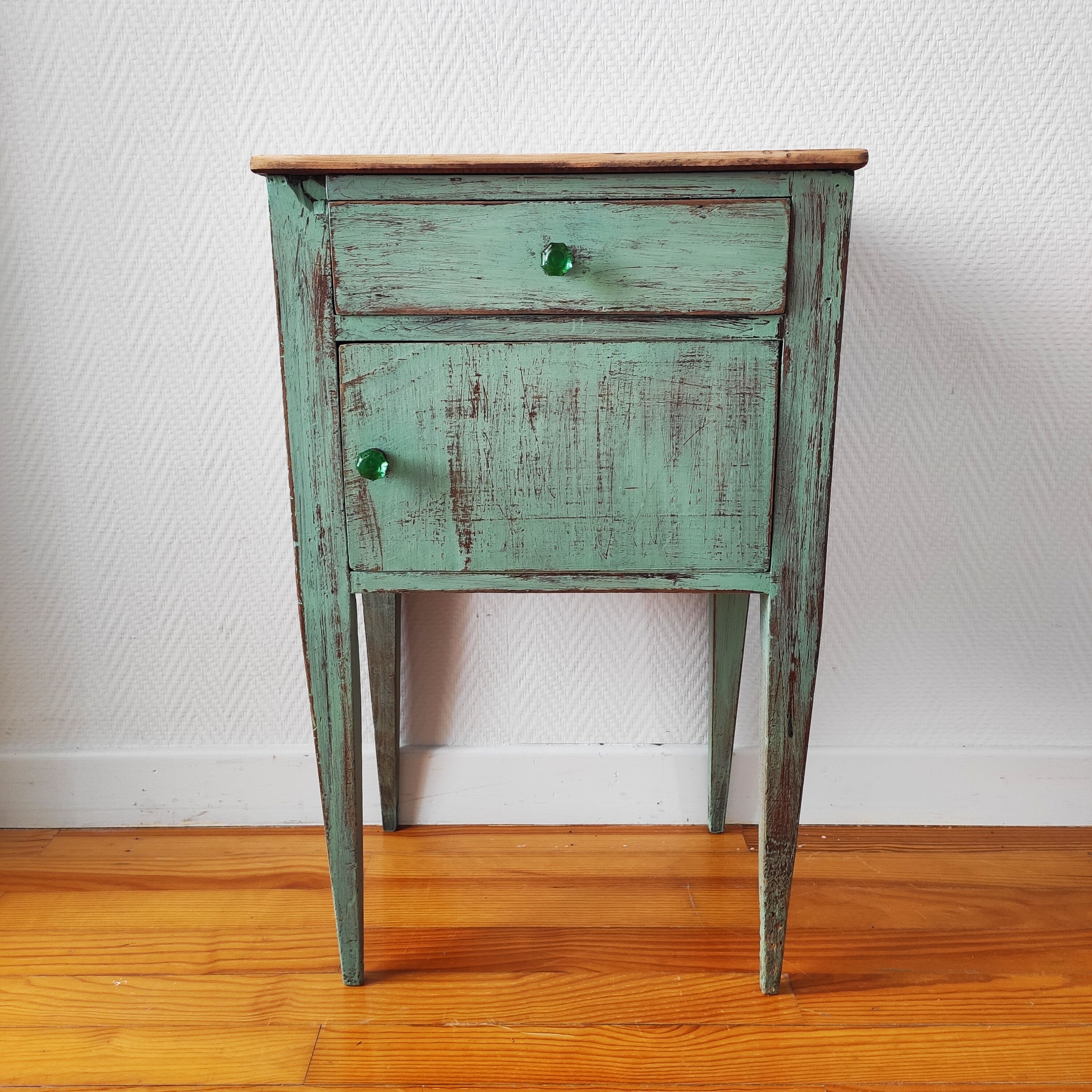 Patinated bedside table end of sofa
