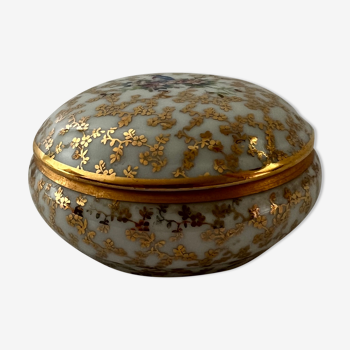 White and golden pill box with a blue bird
