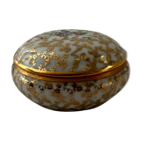 White and golden pill box with a blue bird