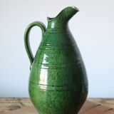 Green old pitcher in glazed terracotta