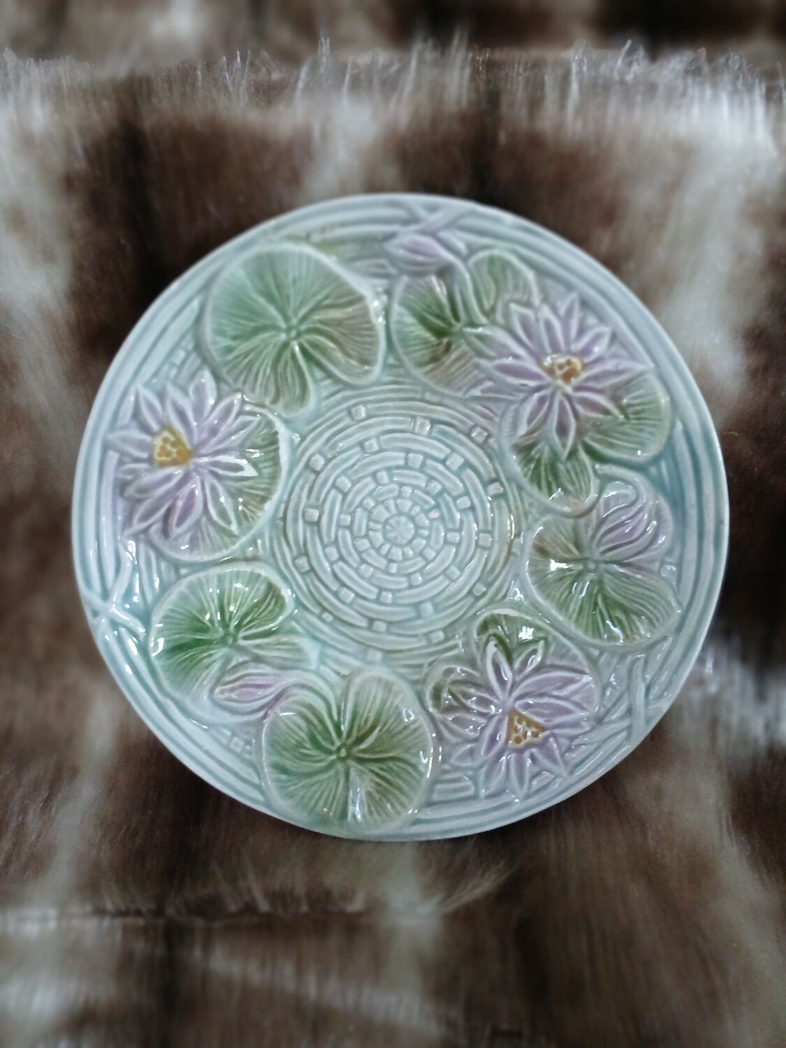 Antique cup and saucer in majolica.