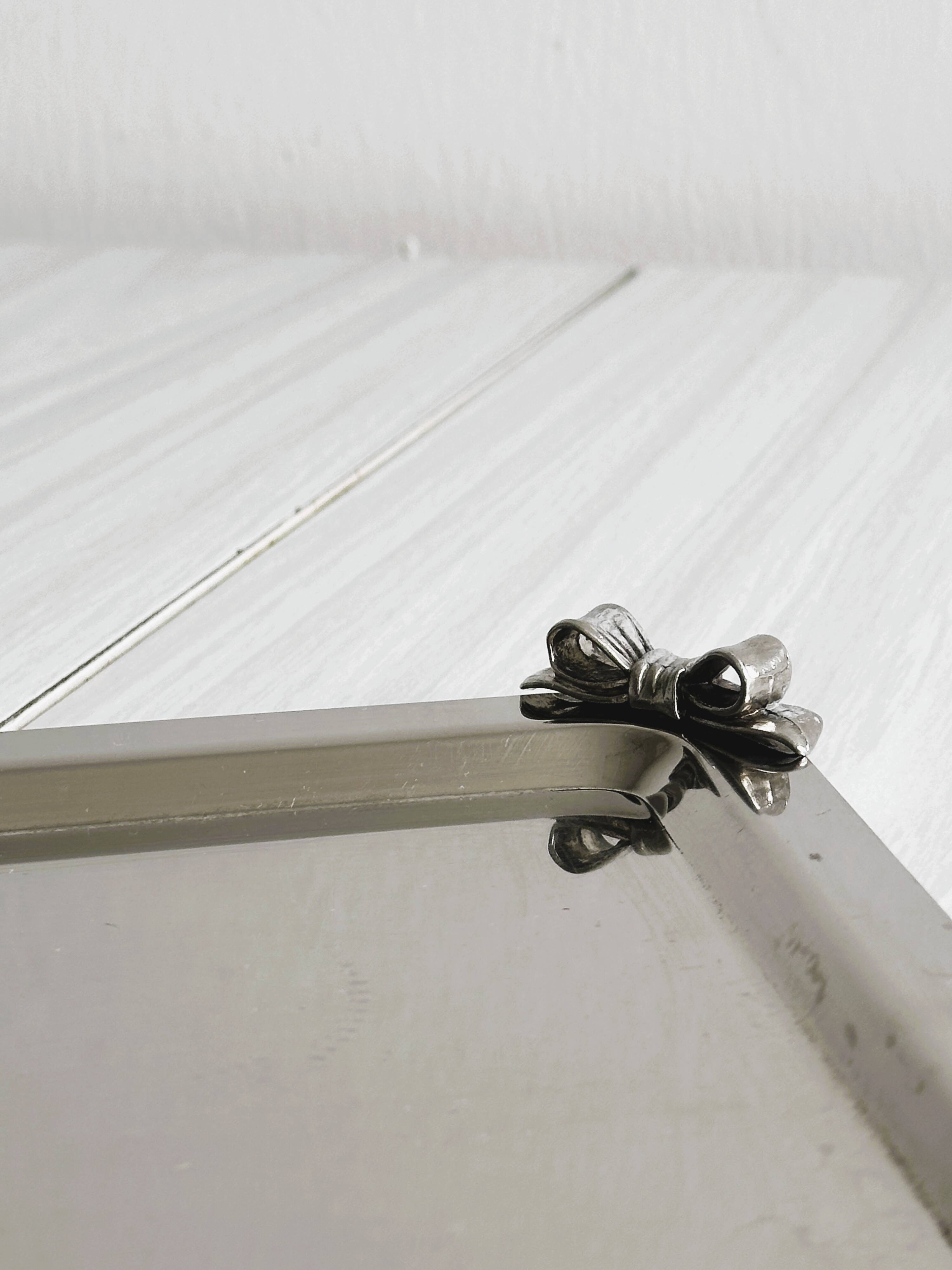 Small vintage metal tray with decorative knot