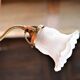 Brass gooseneck wall lamp and tulip lampshade