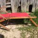 Former pliante long chair - wood foot rest - vintage red fabric