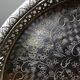 Small Moroccan tripod tea tray in silver-plated metal, vintage chiseled decoration.