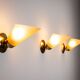 Set of three brass sconces with decorated yellow glass shades