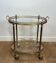 Oval brass rolling table in the style of Maison Jansen. Circa 1940.