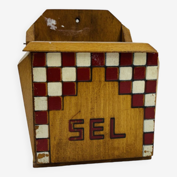 Old wooden salt box with red and white checkerboard decoration