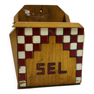 Old wooden salt box with red and white checkerboard decoration