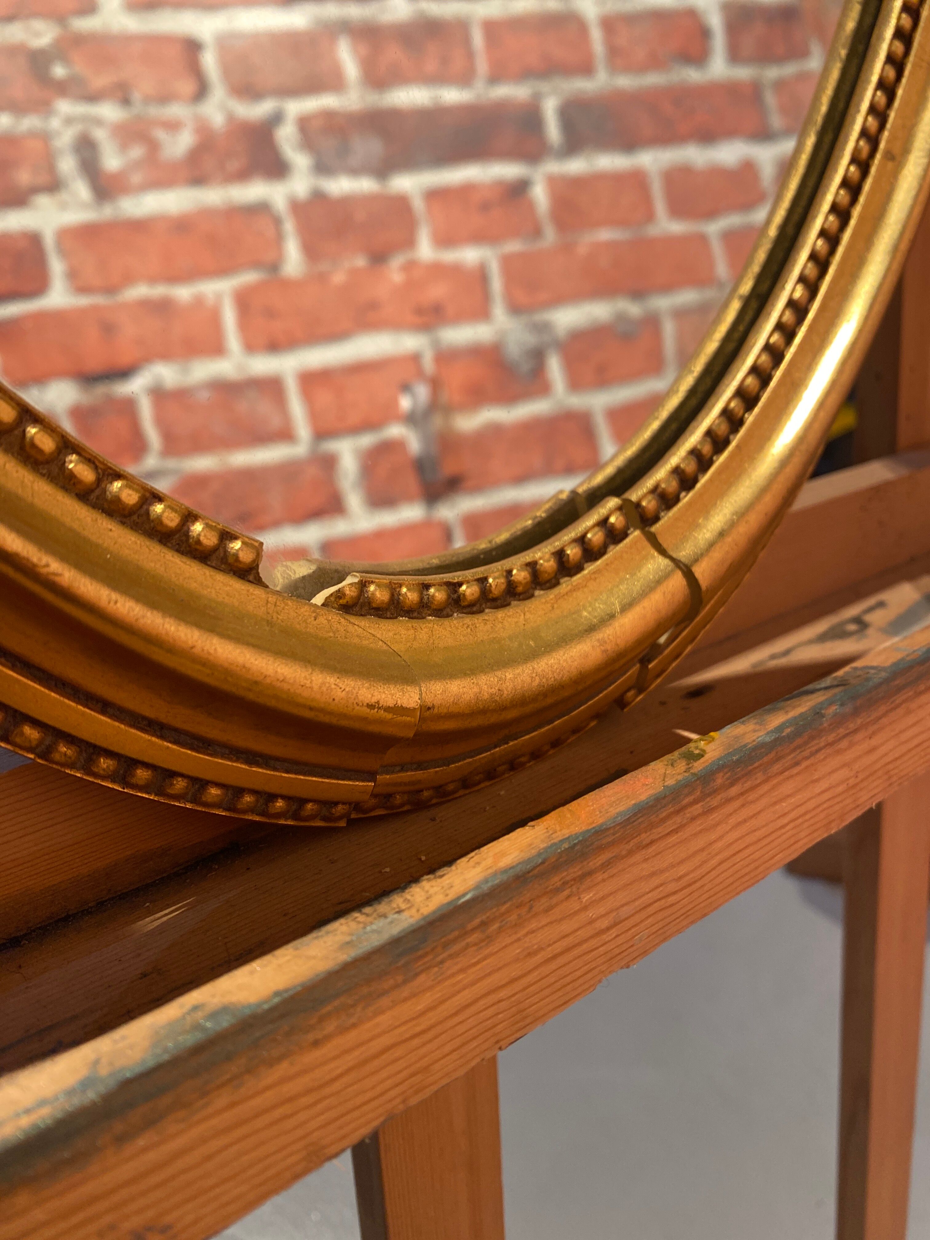 Oval mirror in a frame