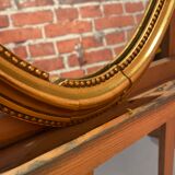 Oval mirror in a frame