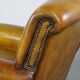 Fauteuil confortable de style anglais en cuir jaune de grande taille avec une finition soignée et des clous décoratifs
