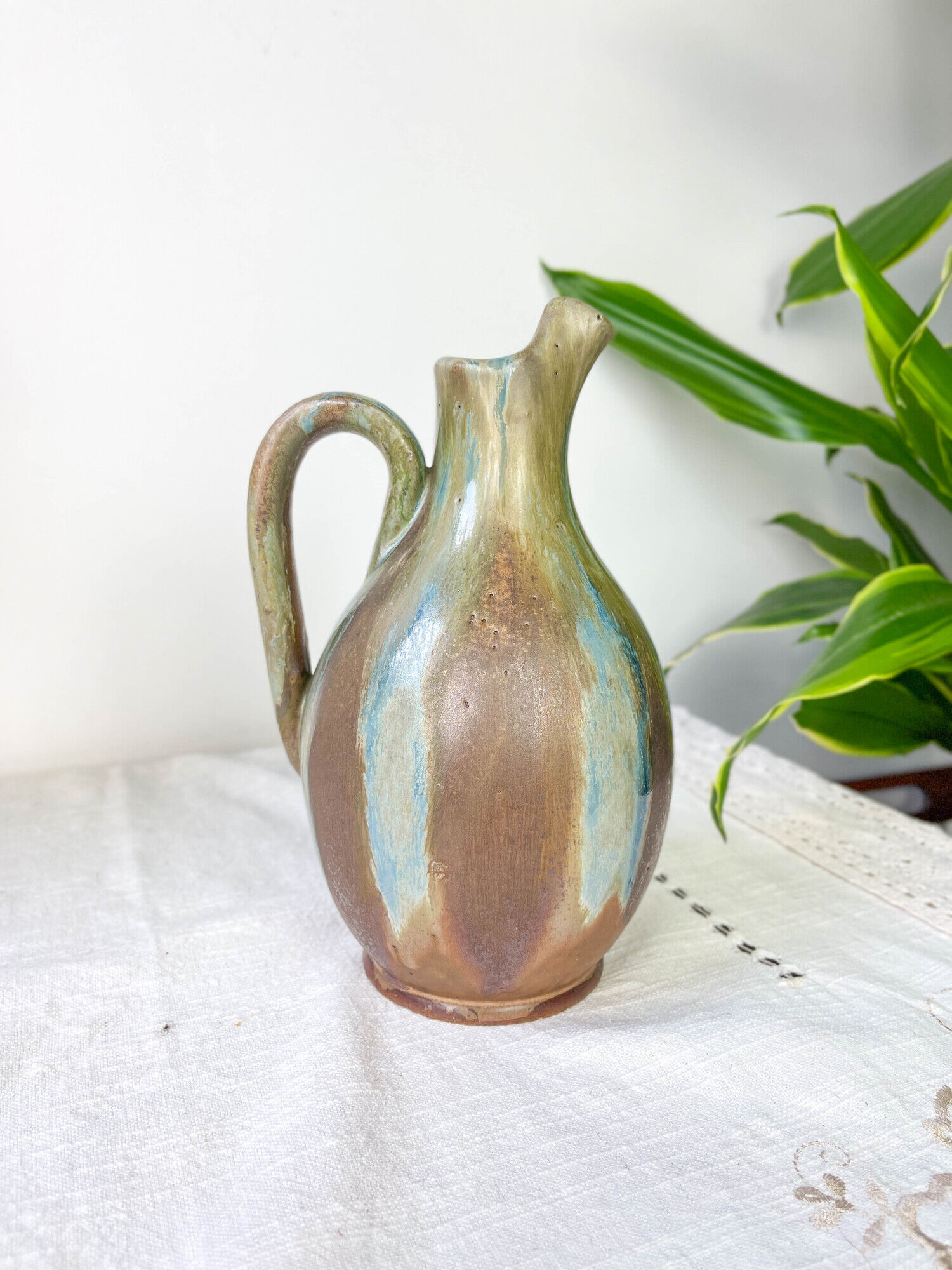 Art Nouveau style carafe in flamed stoneware with blue and brown drips