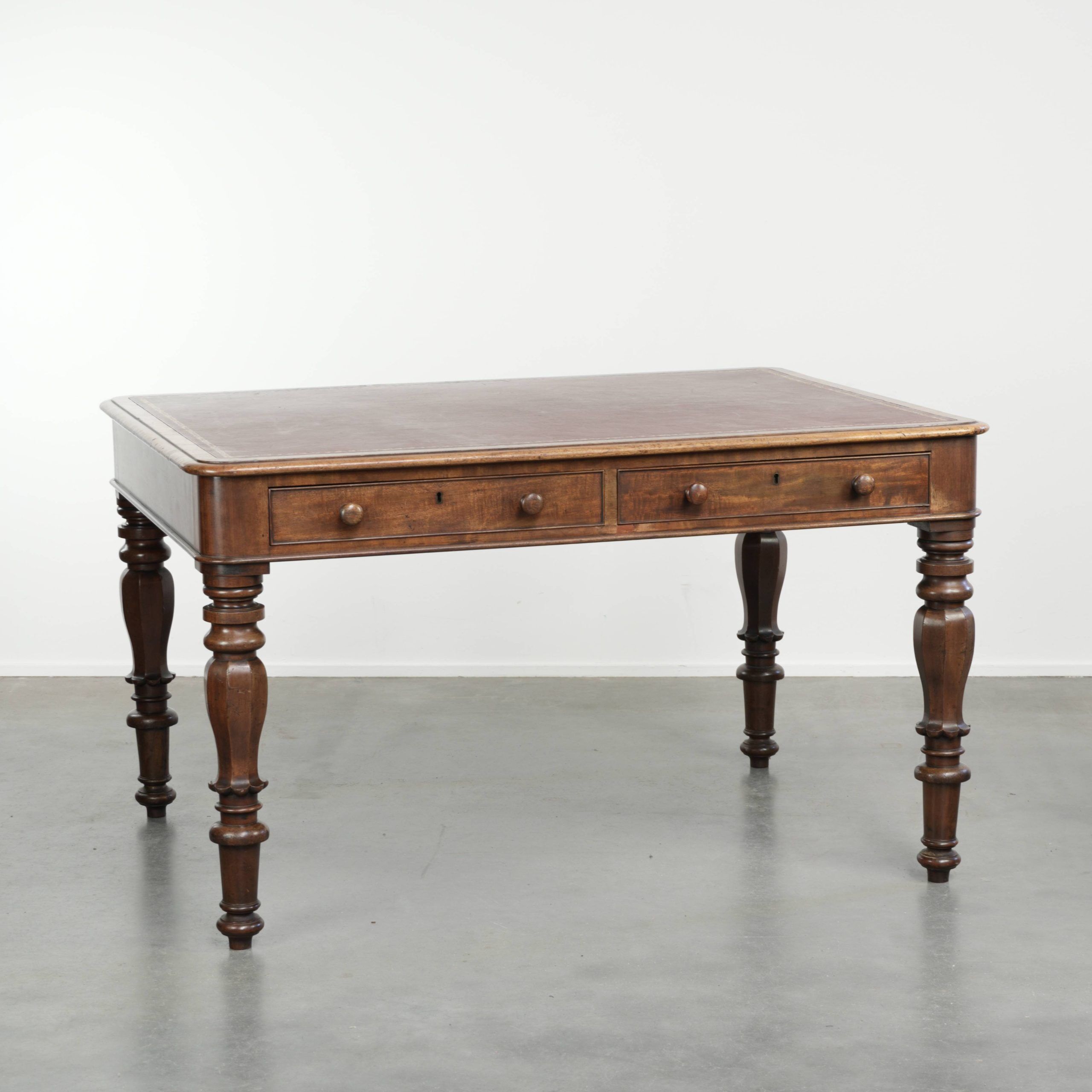 Antique English writing desk from the 19th century with a red leather top