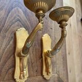 Pair of bronze wall sconces with outstretched arms and hands