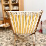 Vintage folding deckchair with yellow striped canvas