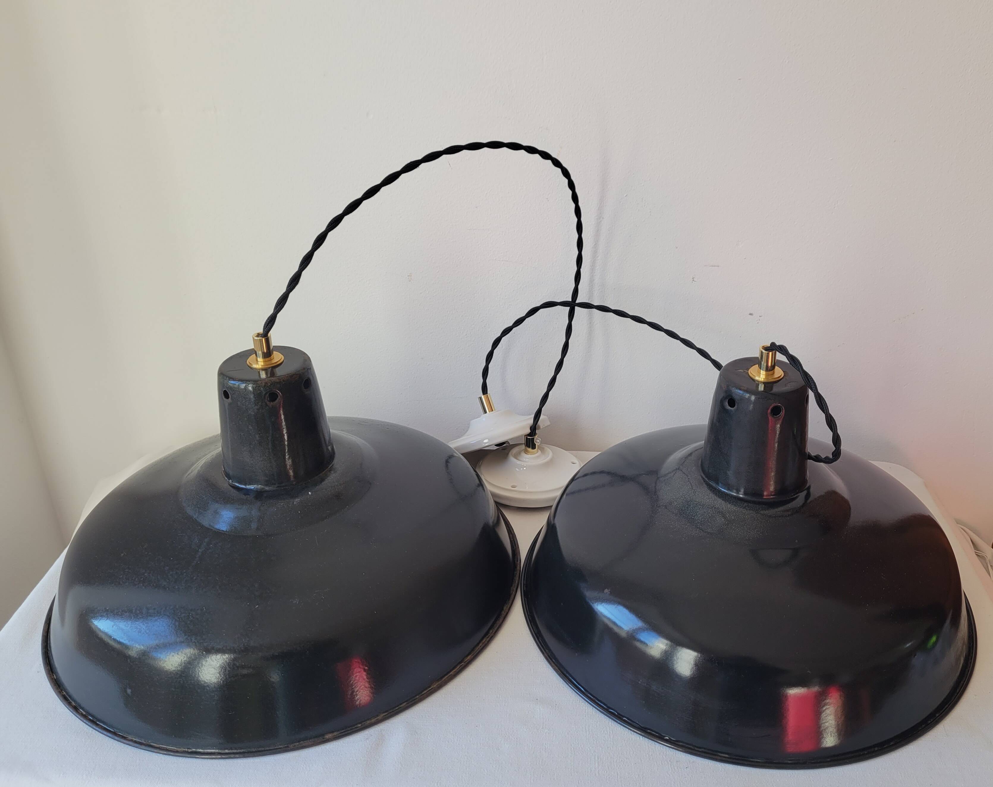 Duo of white and black enameled sheet metal pendants