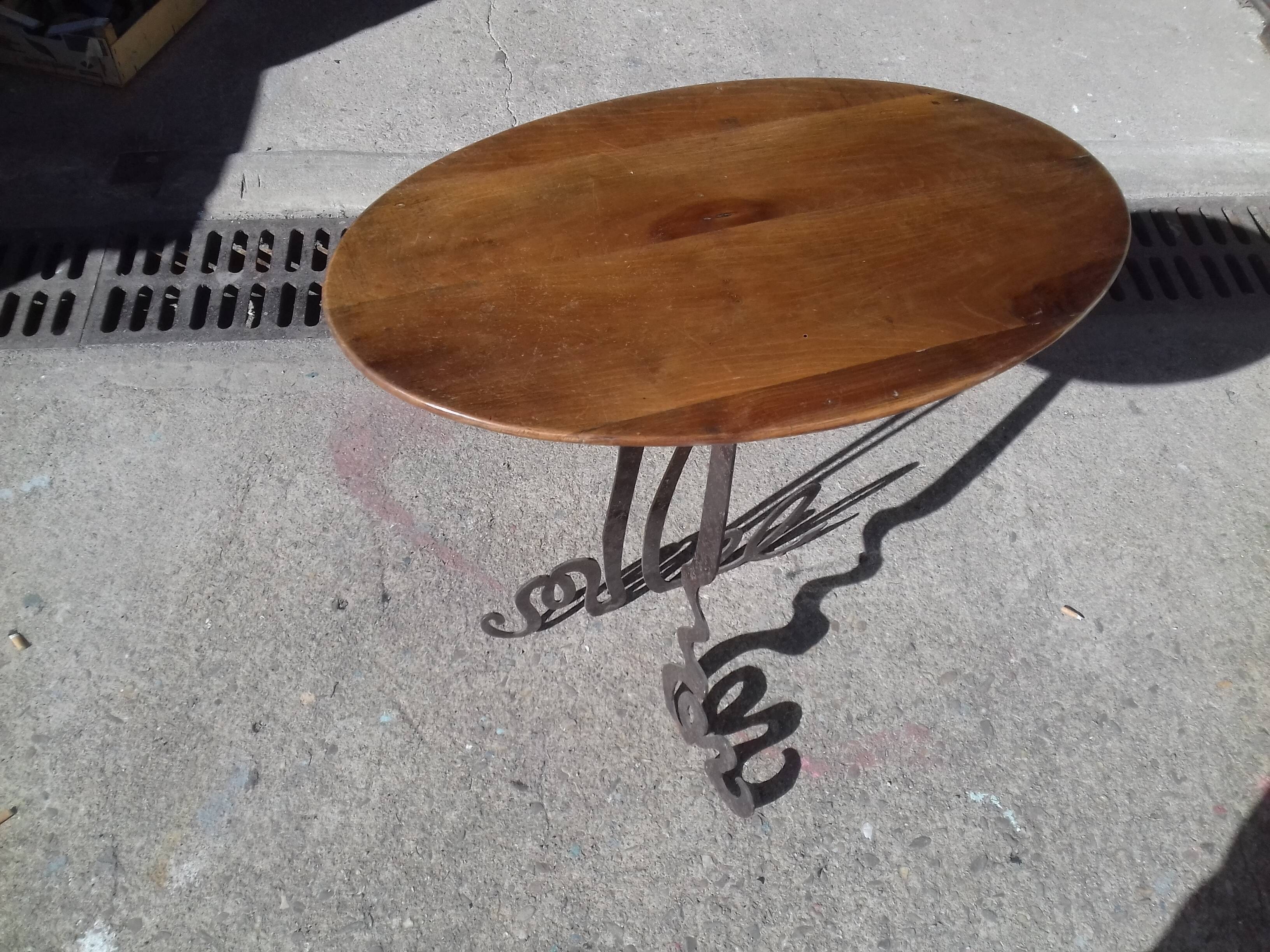 Steel side table with an oval walnut top