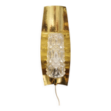 Older wall lamp in brass with hard pressed glass shade.