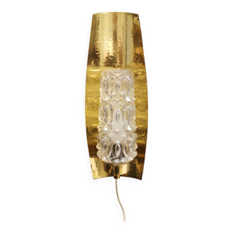 Older wall lamp in brass with hard pressed glass shade.